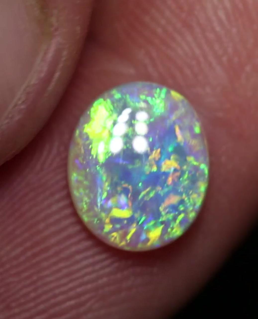 Galaxy crystal opal, rainbow colours inside this gorgeous australian gemstone by black opal direct; minerals and gemstones