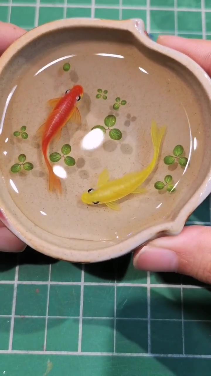 Vibrant red and yellow koi fish acrylic painting on resin layers - a stunning artwork; mesmerizing acrylic painting process: koi fish on resin layers in bamboo container