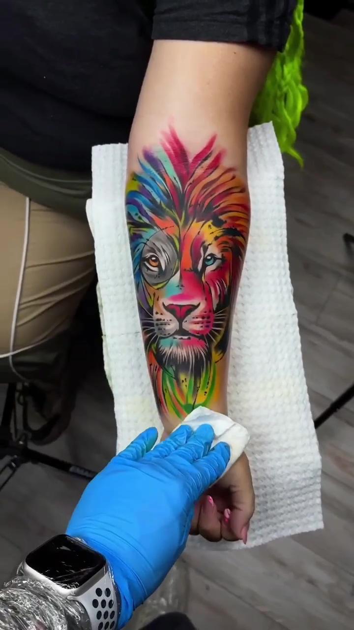 Colorful lion face tattoo; arm cover up tattoos