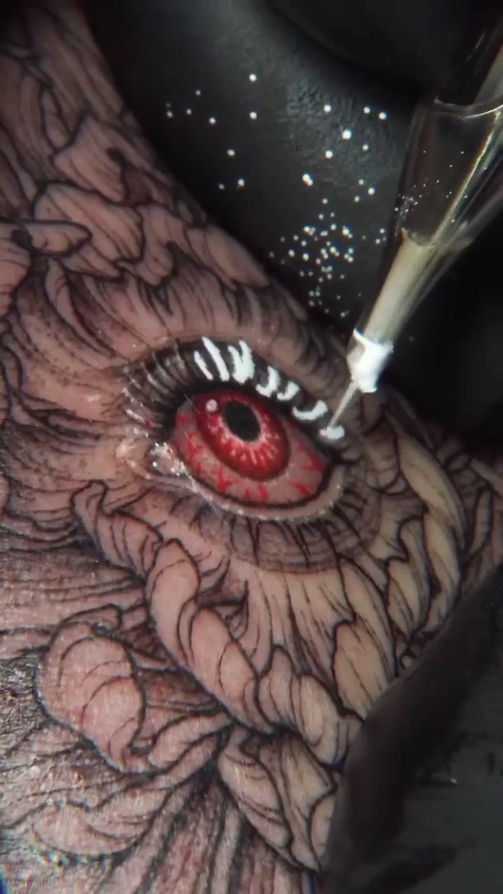 Process of inking flower with eye tattoo by  tattooer_intat; funky tattoos