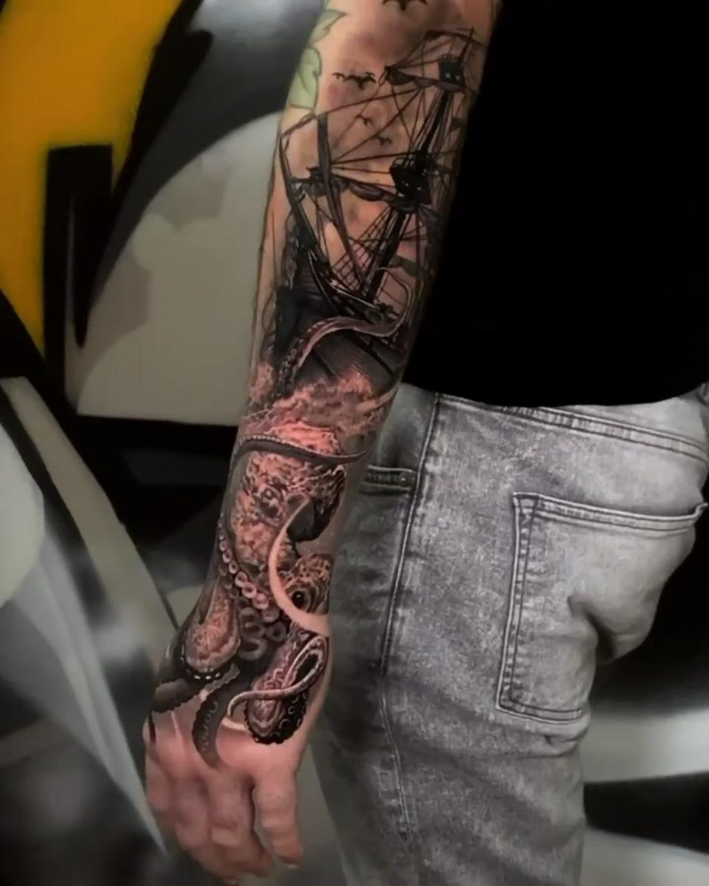 Black and grey tattoo on arm; octopus tattoo sleeve